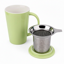 Load image into Gallery viewer, Green mug with a metal tea infuser on a white background